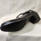 Sole of Black broad heel patent pumps