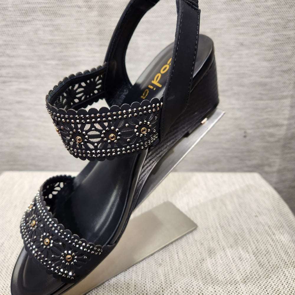 Side view of black sandals with stone embellished upper straps