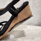 Detailed view of tan colored heel of black upper summer sandal
