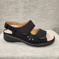 Another side view of black orthopedic sandal with velcro
