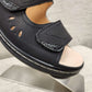 Detailed front view of black orthopedic summer sandal