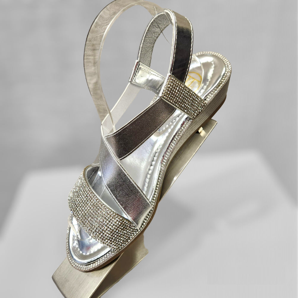 Side view of silver sandals with stones and sling back