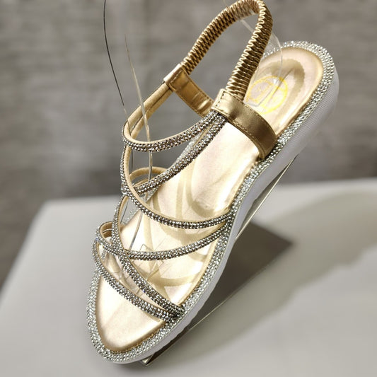 Side view of gold stone studded strapy summer sandals