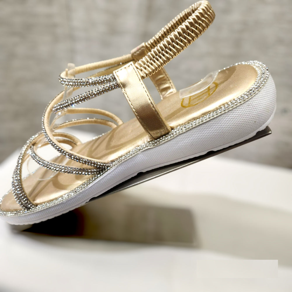 White wedge type heel of gold stone studded strappy summer sandal