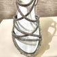 Detailed view of stone studded straps of silver strappy summer sandals