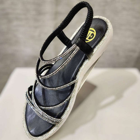 Side view of black stone studded strappy summer sandals