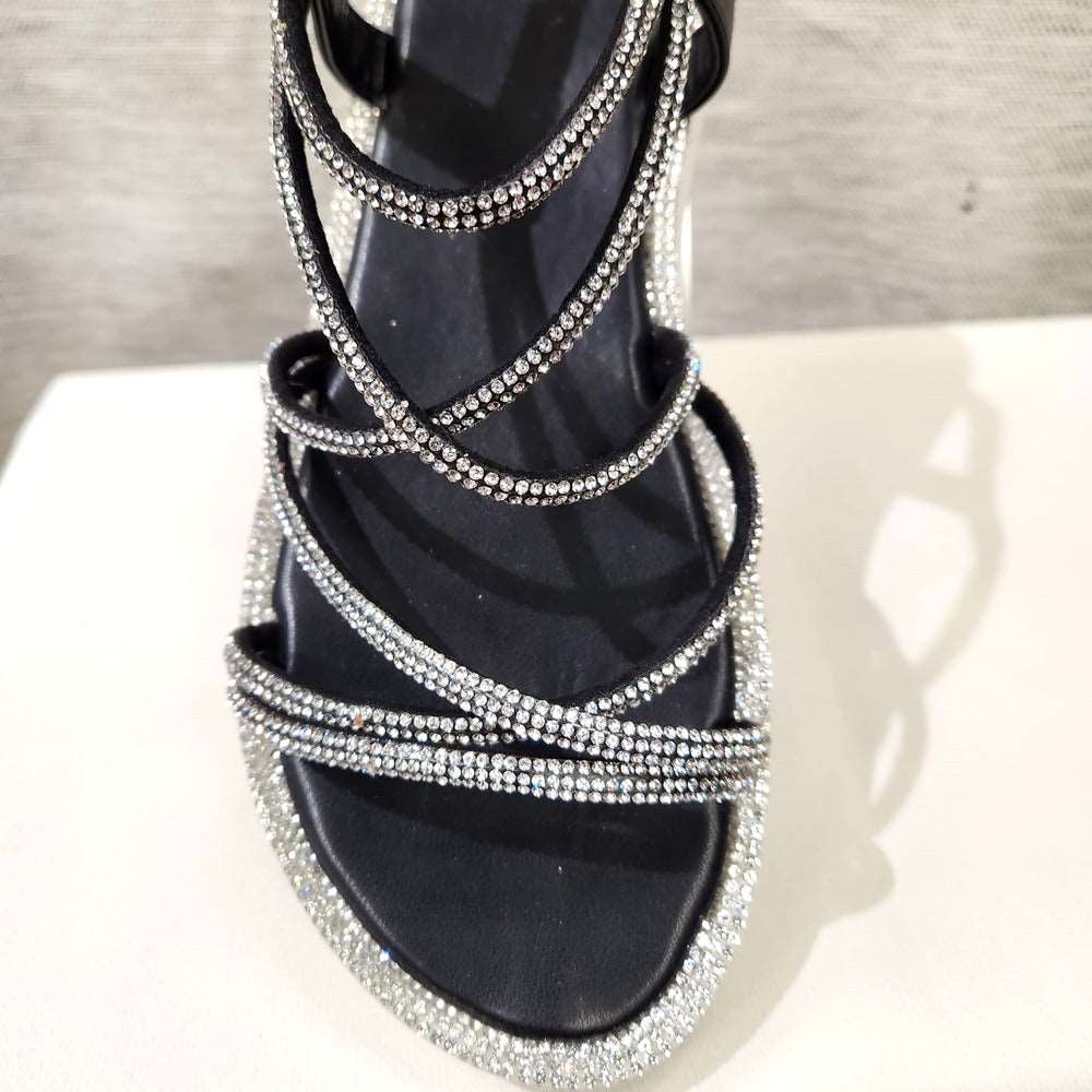 Detailed view of the front of black strappy stone studded sandals