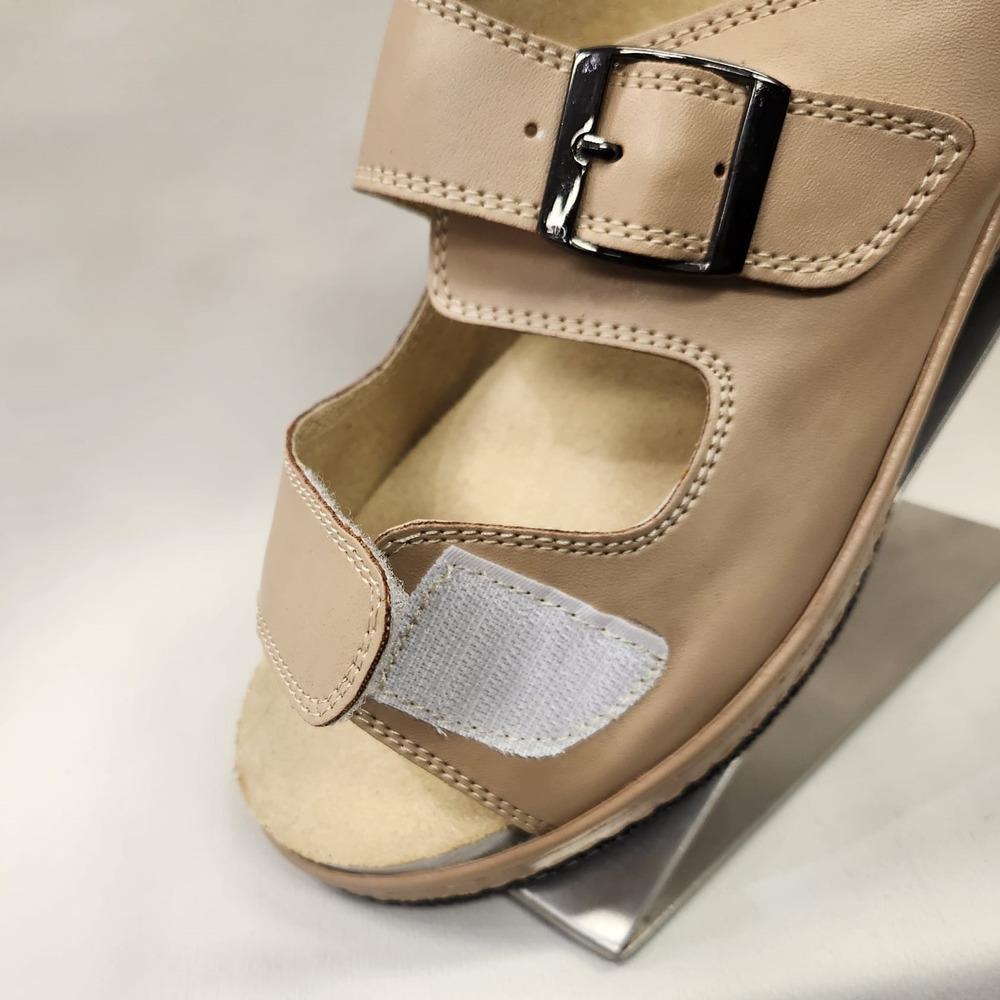 Velcro closure of slip on beige summer sandal
