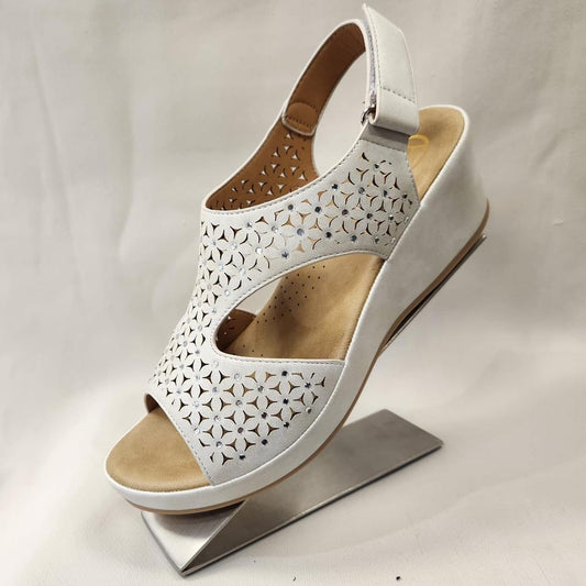 Side view of Elegant white summer sandal with velcro closure back strap