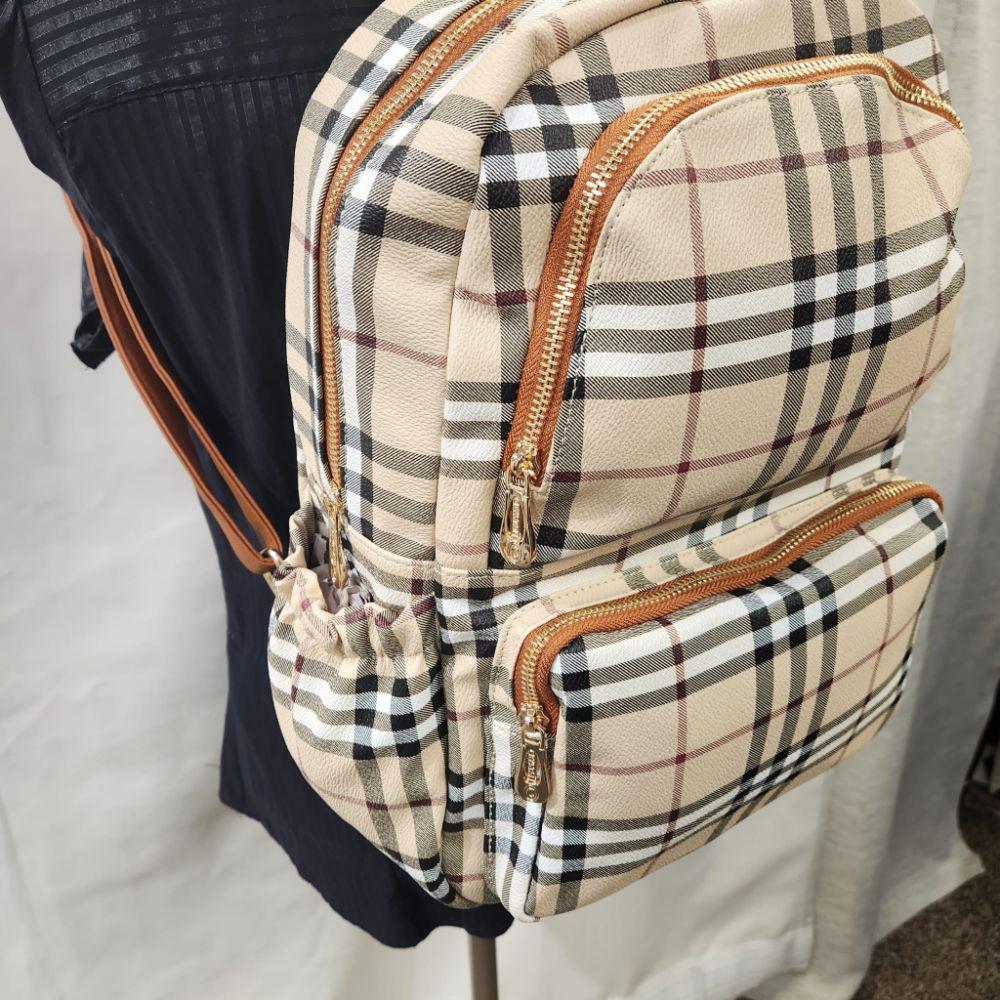 Detailed view of multiple compartment plaid pattern backpack