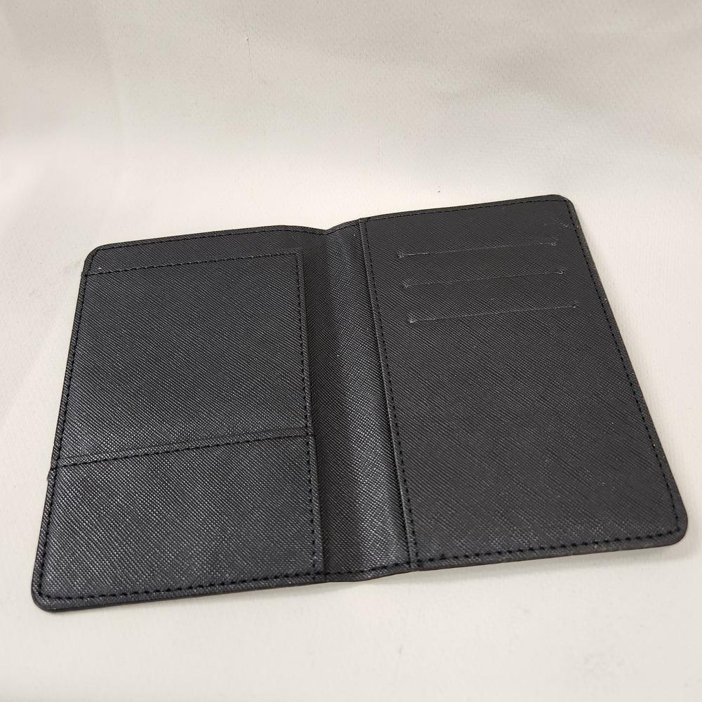 Passport cover in black and grey club print when opened