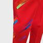 Detailed view of red leggings with colorful pattern