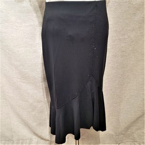 Detailed view of Black skirt with flared hemline and self color stones