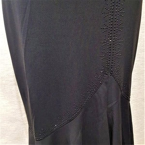 Detailed view of stone embellishment on black skirt