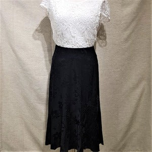 Full view of Flared black skirt in self print embellished with stones