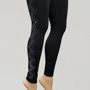 Black leggings with wavy pattern adorned with silver stones  on outer sider