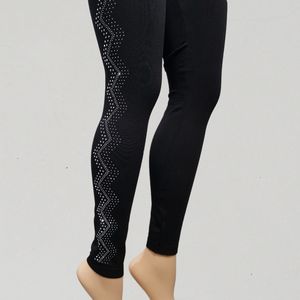 Black leggings with wavy pattern adorned with silver stones on outer sider