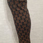 Detailed view of GD signature print on black leggings