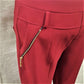 Gold side decorative zipper detail of warm red leggings