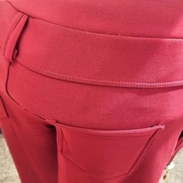 Belt loop detail of warm red leggings