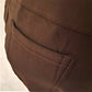 Back pocket details of warm leggings in brown