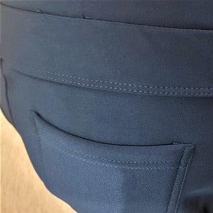 Back pocket detail of warm leggings in teal blue color