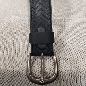 Detailed view of buckle and upper side of leather belt 