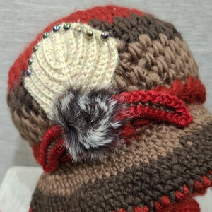 Detailed view of floral design on red winter cap
