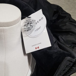 Detailed view of the tag on Winter jacket in black color