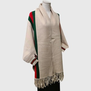 Full view of Cream colored cape with sleeves