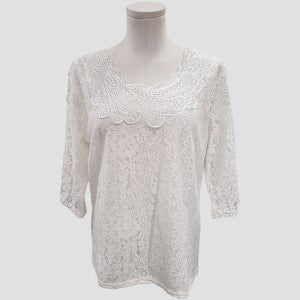 Formal lace top in white with decorative detail around neckline