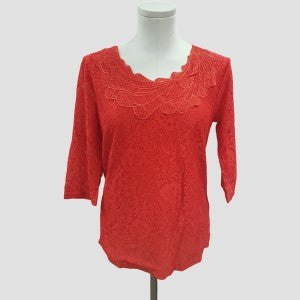 Formal lace top in red with decorative detail along neckline