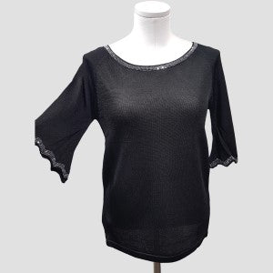 Top with decorative details along neckline and sleeves