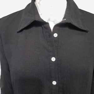 Pointed collar detail of black button down dress shirt 