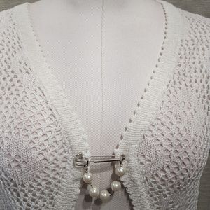 Detailed view of white crochet shrug with short sleeves