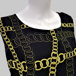 Detailed view of black and green printed top's neckline