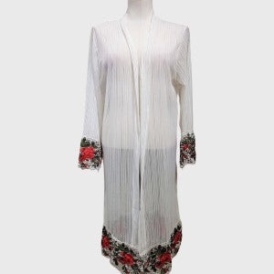 Full view of white long sheer material shrug with colorful lace