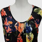 Neckline of dress in black with colorful floral print