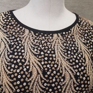 Neckline of black and beige casual top in vibrant print