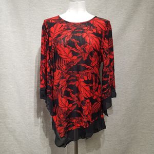 Full view of printed black and red top with asymmetric hemline