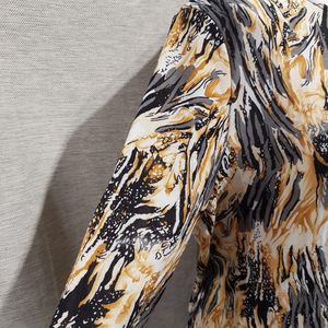 Side view of graphic print top with gathering in front