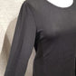Side view of black top with fold over hemline