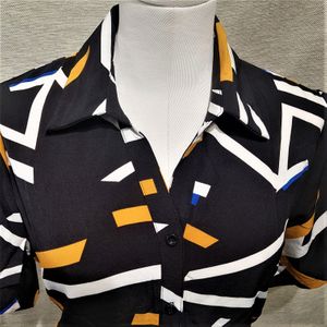Collar detail of dress shirt in black with yellow and white print