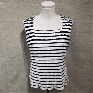 Full view of white and black ruffled top