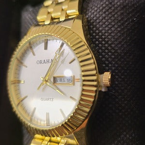 Side view of Round face gold frame wristwatch for men