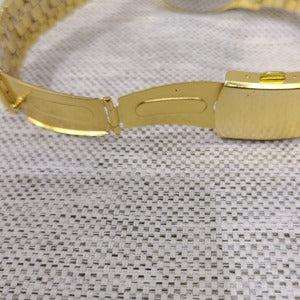 Folding clasp on gold wristwatch for men