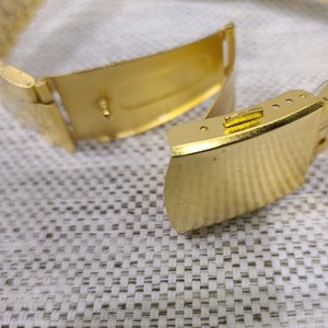 Another view of folding clasp on gold wristwatch