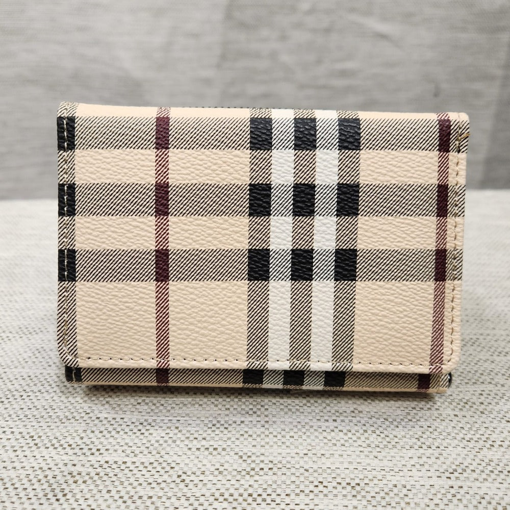Small wallet in beige with colored plaid pattern when closed