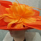 Feather embellishment on orange dress hat