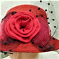Detailing on red cloche hat 